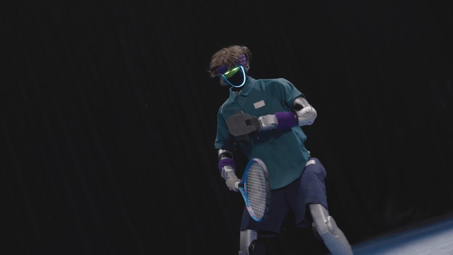 Humanoid research robot holding a tennis racket in the AdaPT demonstration