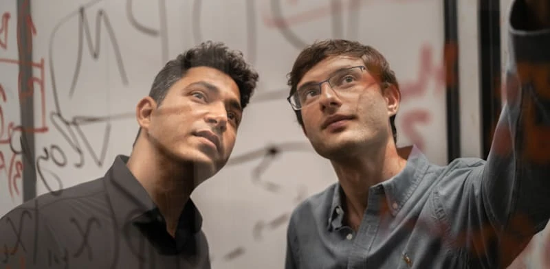Decart founders Moshe Shalev and Dean Leitersdorf at a transparent writing board